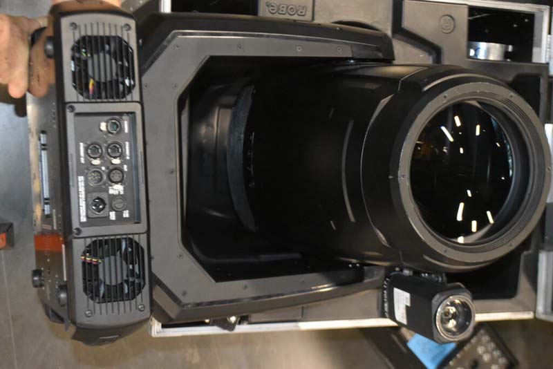 Close-up of a stage lighting fixture with control ports and cooling fans.