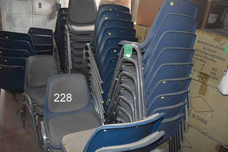 Piles of blue chairs in the room for auction