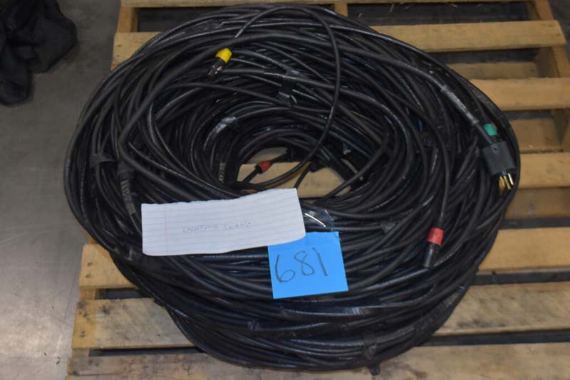 Coil of black cables with colored connectors on a wooden pallet, labeled "ROSETTA STONE" and "681".
