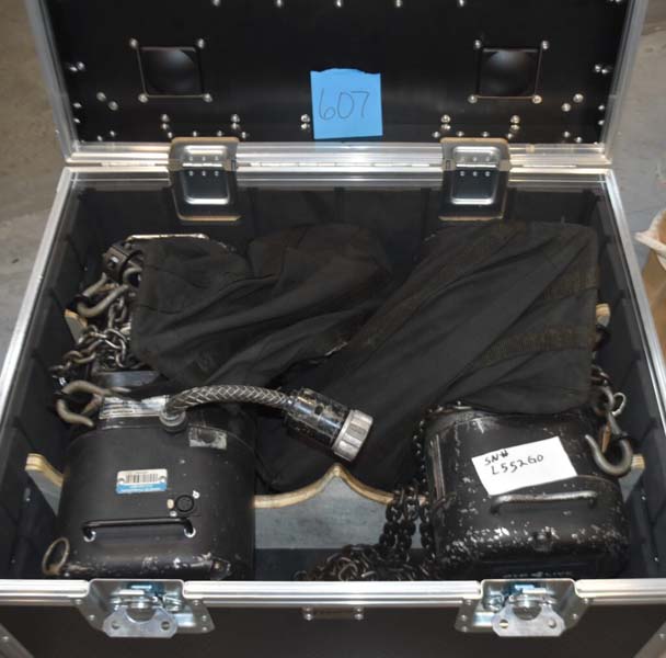 Open black storage case labeled "607" with two motorized hoists and cables.