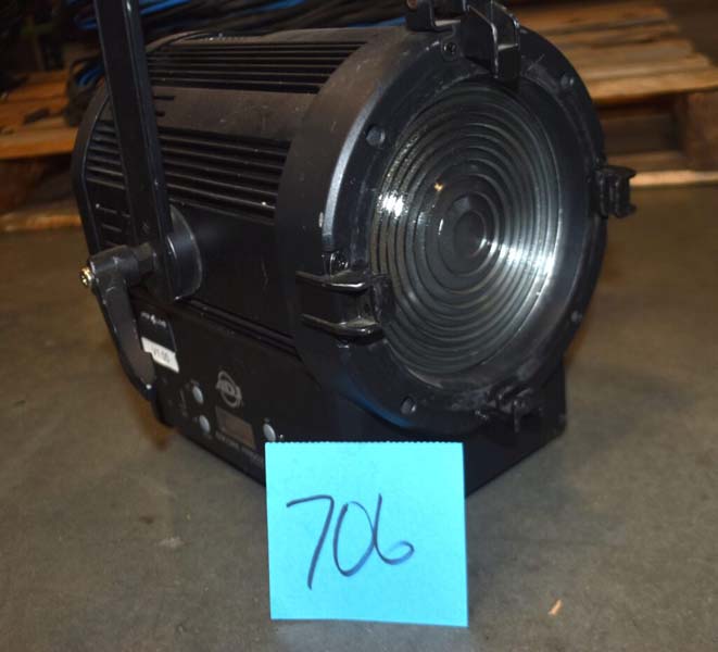 Black stage light with a Fresnel lens labeled "706".
