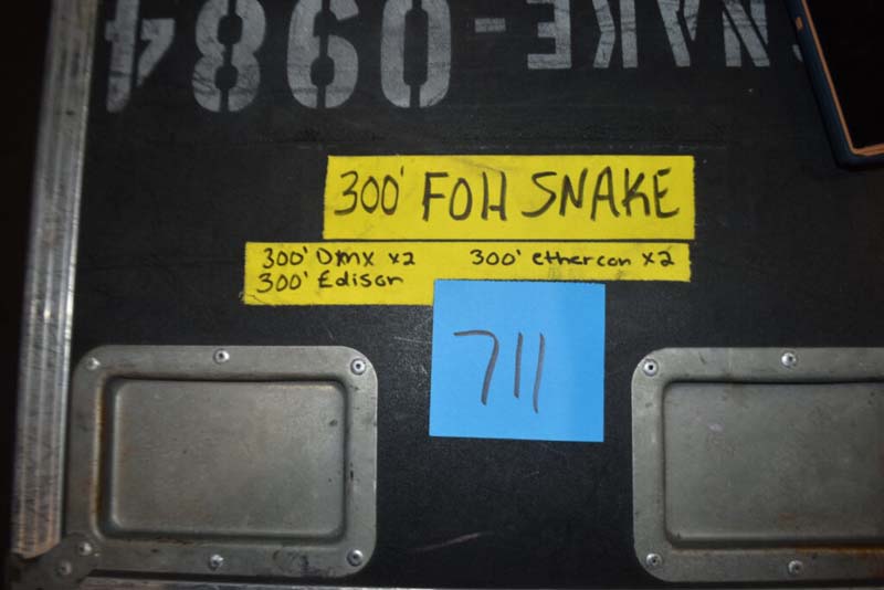 Black equipment case with yellow labels and a blue sticky note labeled "711".