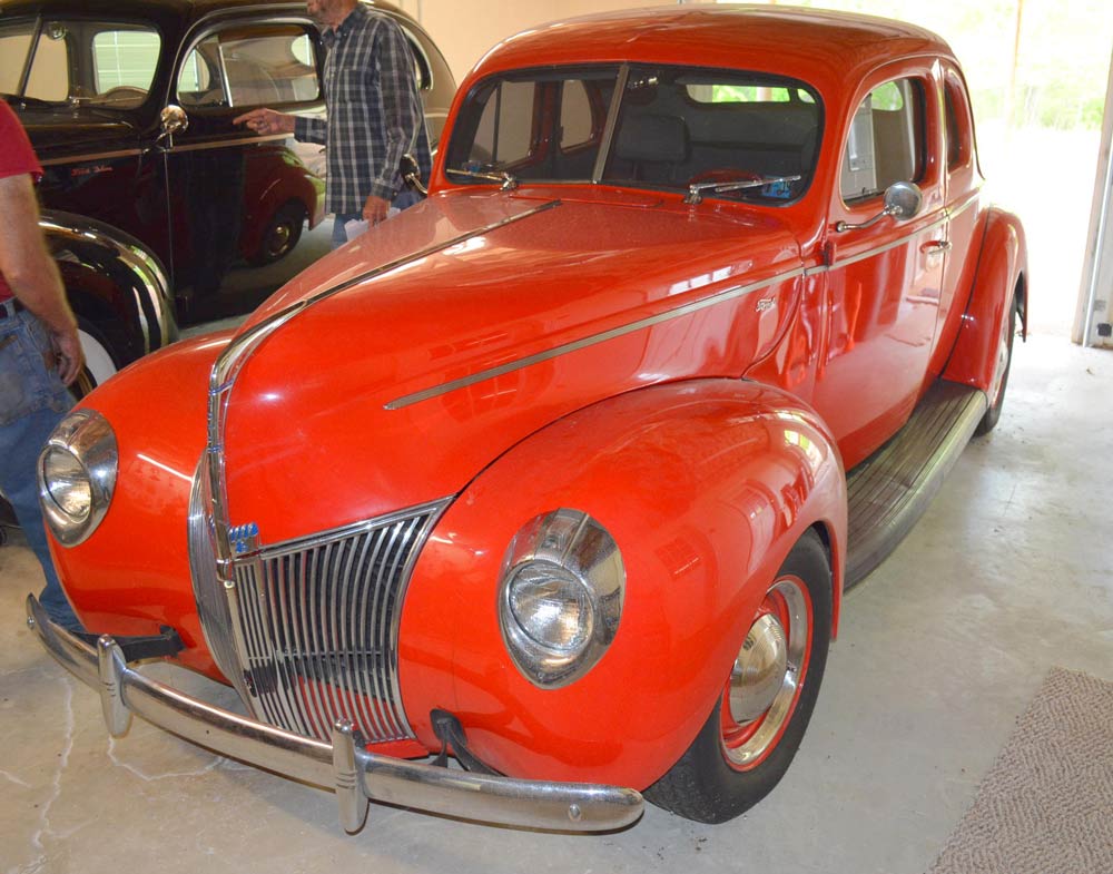 Red old car inside garage